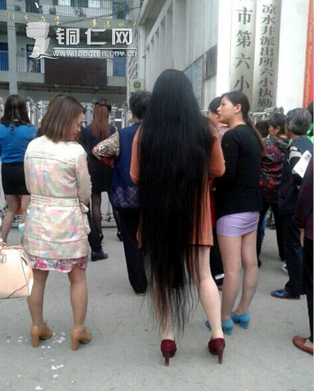 Very long hair lady waiting for her child in front of school