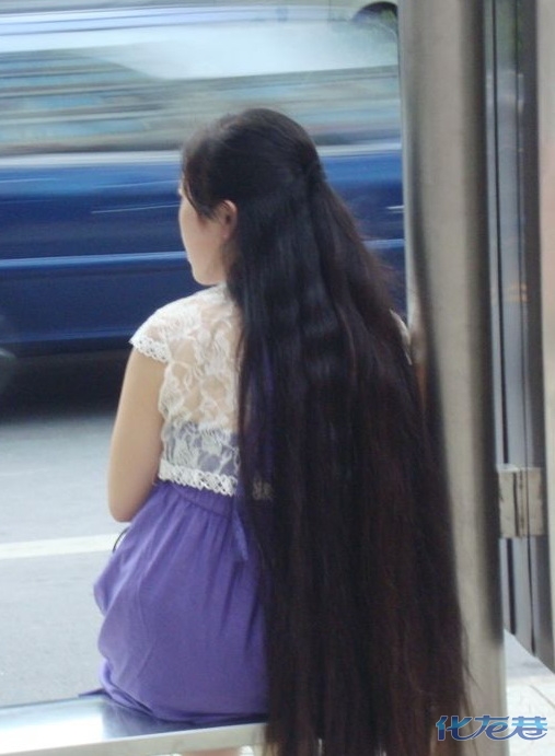 Long hair girl waiting in bus station in Changzhou city, Jiangsu province