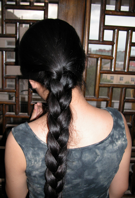 Young girl with knee length thick braid