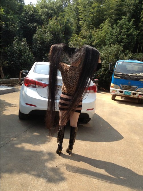 She shew her long hair near a car