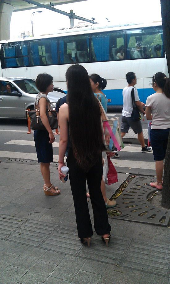 Long hair girl waiting for bus