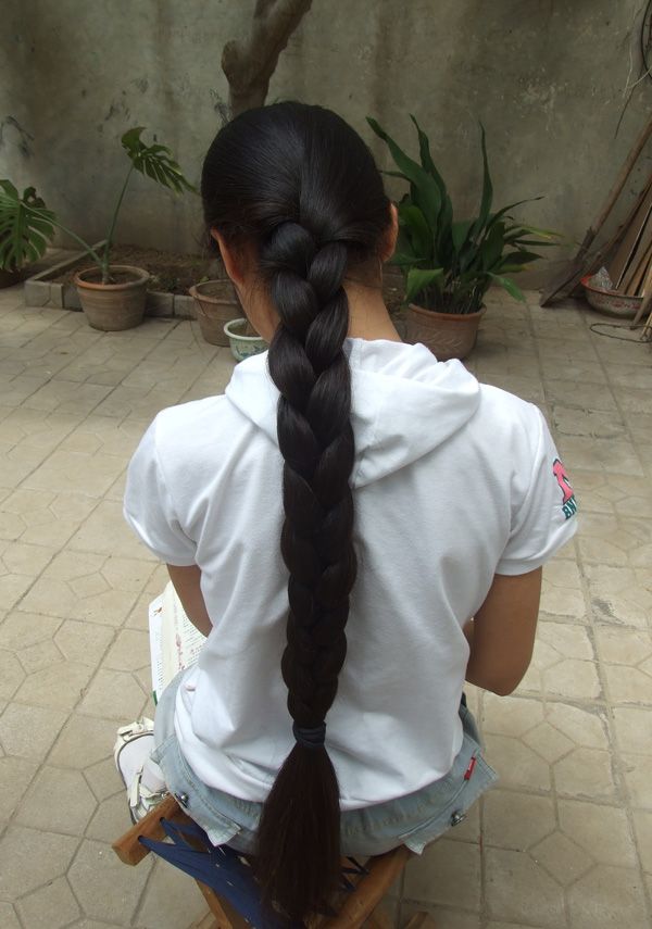 Very thick braid of a young girl in teenage