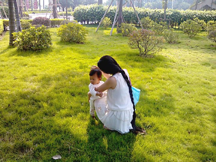 Long hair mother elyglin with her baby