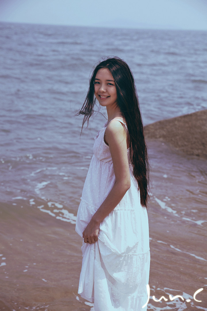 Long hair girl dressed in white skirt looks like a fairy