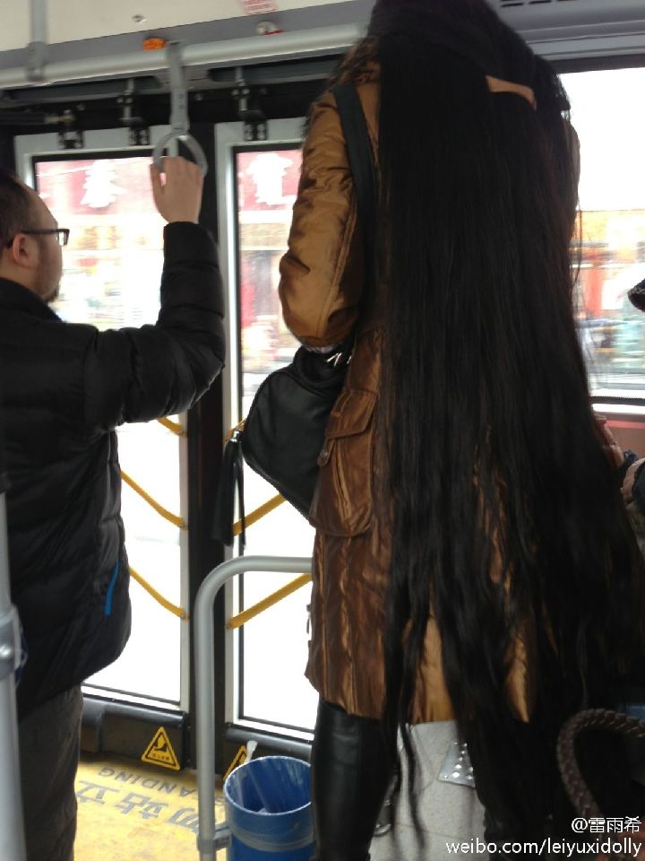 Very high lady with calf length long hair on bus