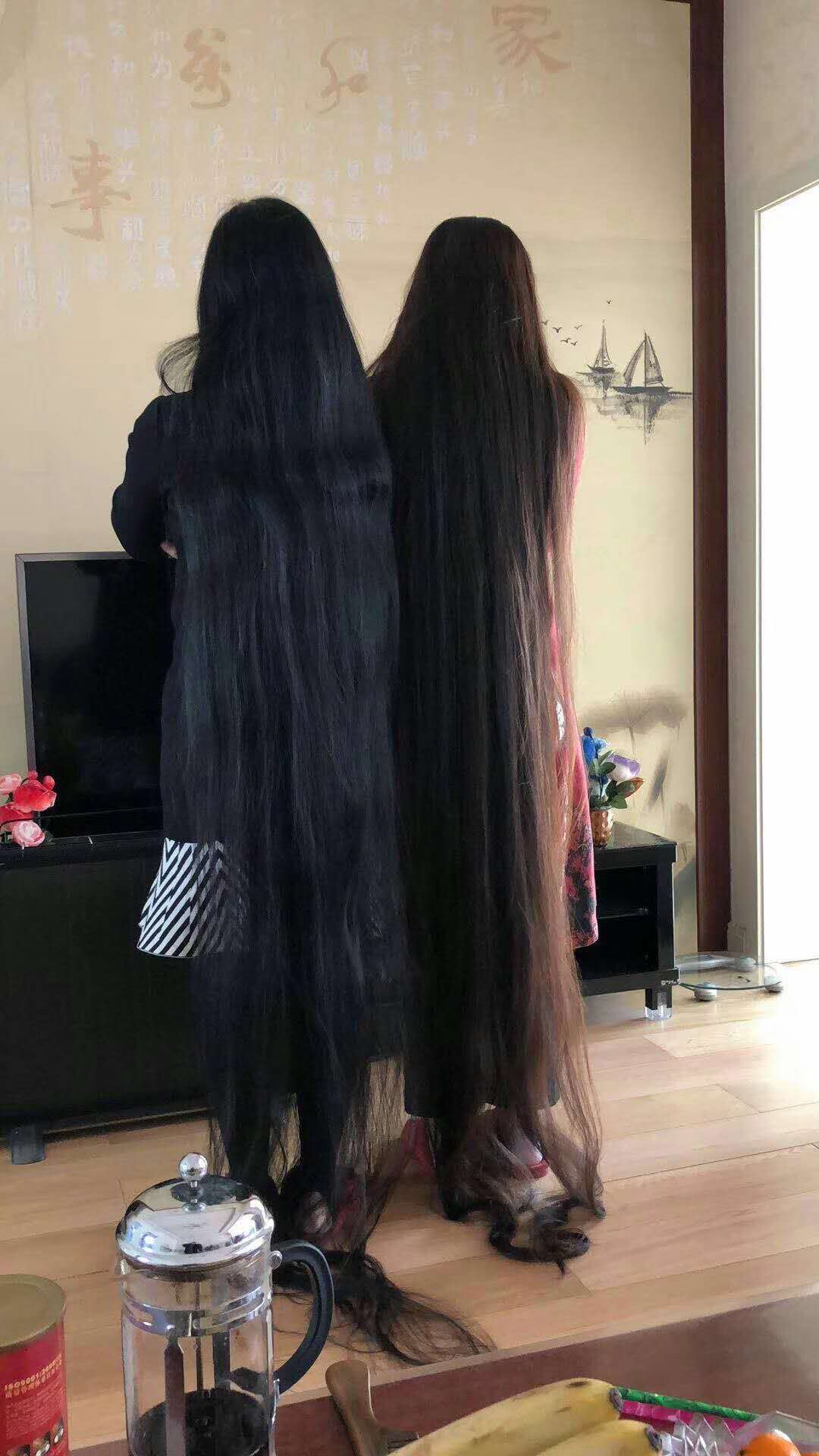2 super long hair ladies stand together