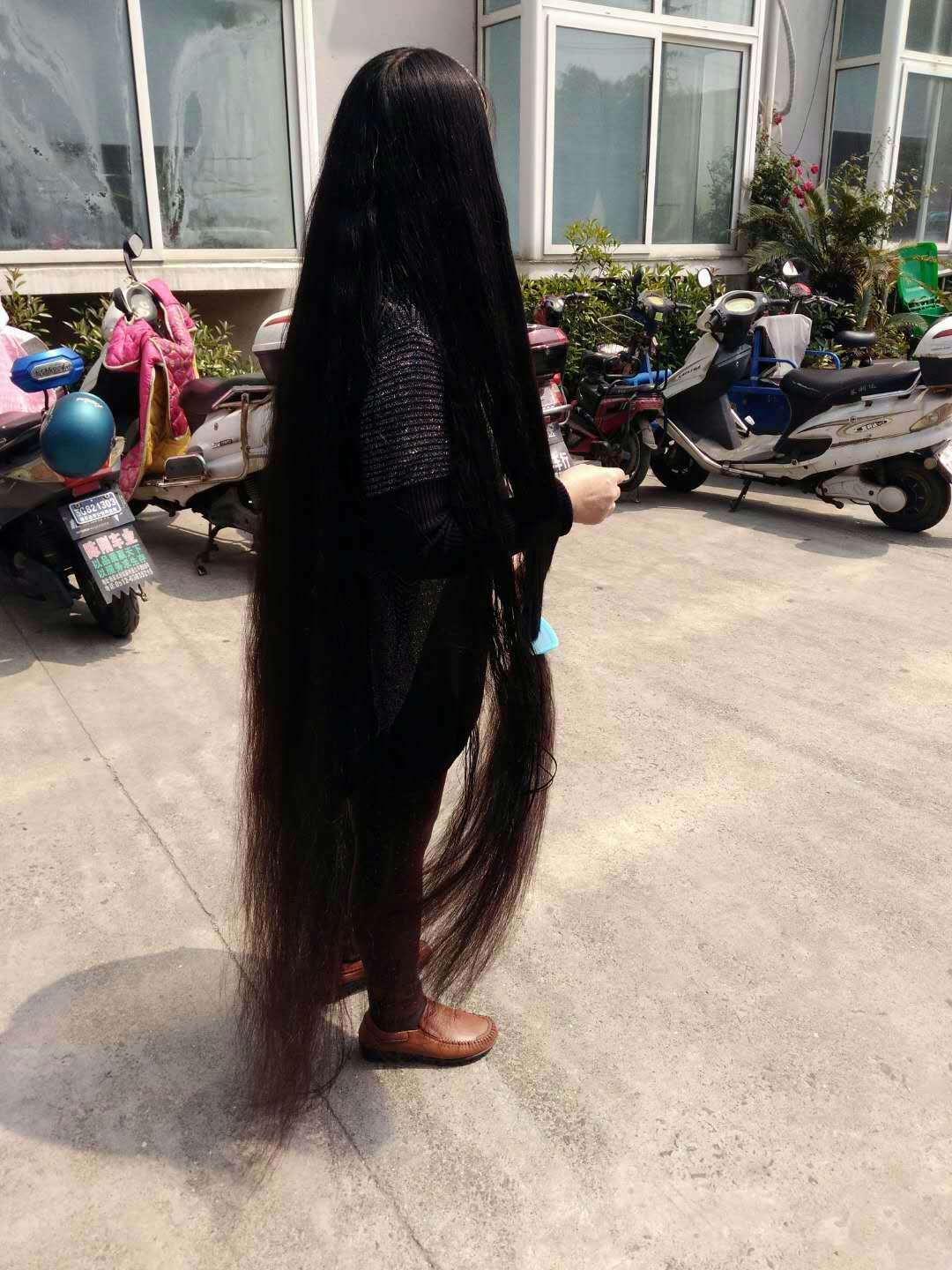 She comb floor length long hair like a cloak