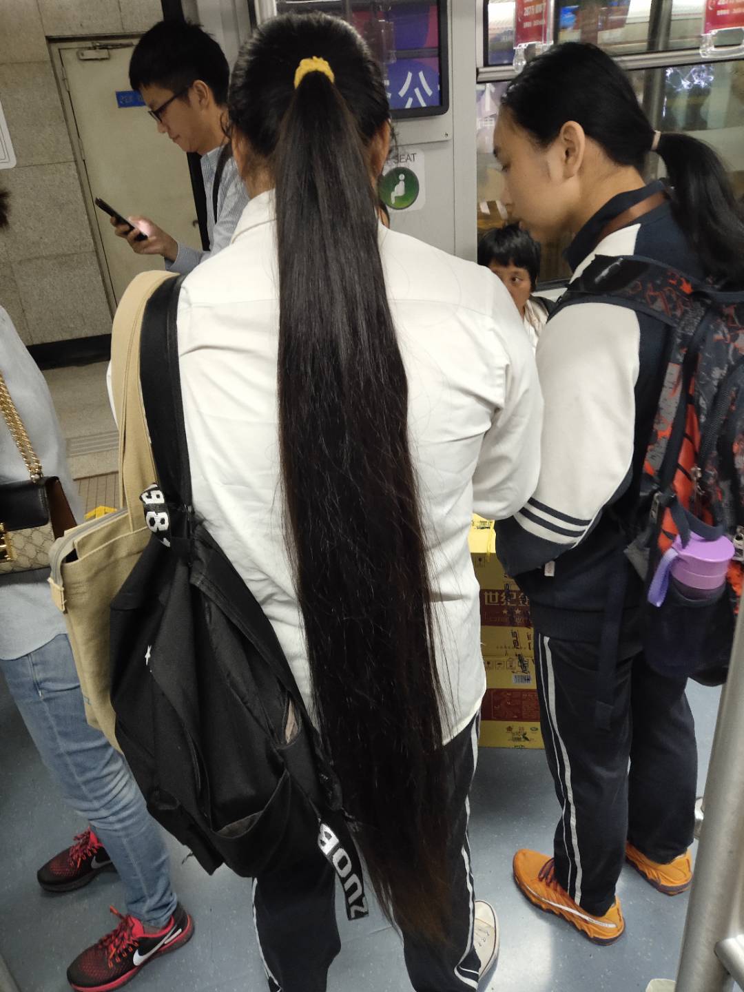 Streetshot of super long ponytail in subway
